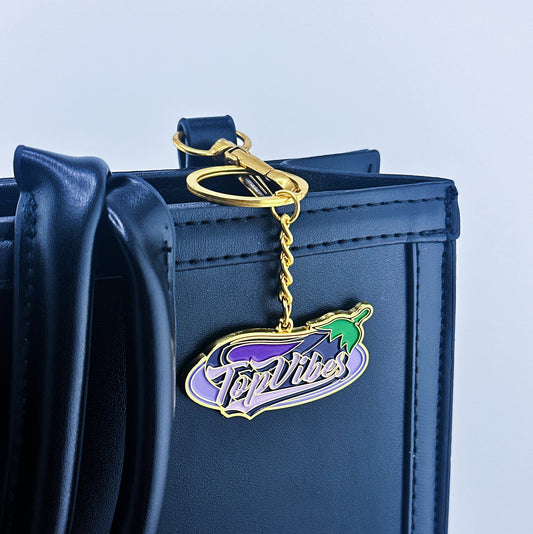 A big eggplant on the back and Top Vibes written in the middle